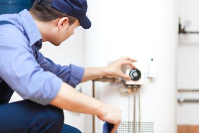 plumber working on hot water system 