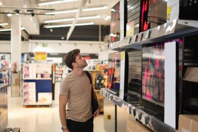 Adult choosing TV in retail store