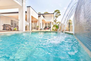 Close up photo of water falling into a swimming pool