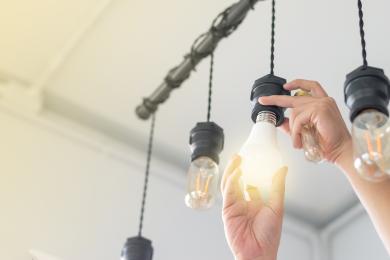 Person replacing a light bulb