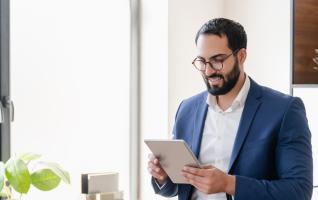 Adult reading from a tablet in an office